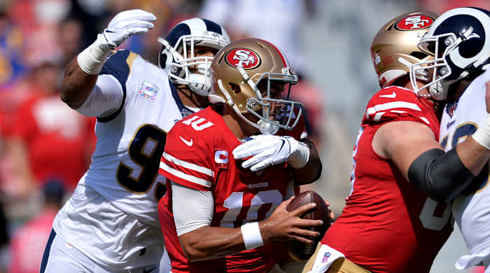 Oct 13, 2019; Los Angeles, CA, USA; San Francisco 49ers quarterback Jimmy Garoppolo (10) is sacked by Los Angeles Rams defensive tackle Aaron Donald (left) during the first quarter at Los Angeles Memorial Coliseum. Mandatory Credit: Orlando Ramirez-USA TODAY Sports